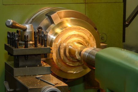 The lathe machine finish cut the brass material parts by lathe tools. The metalworking process by turning machine.