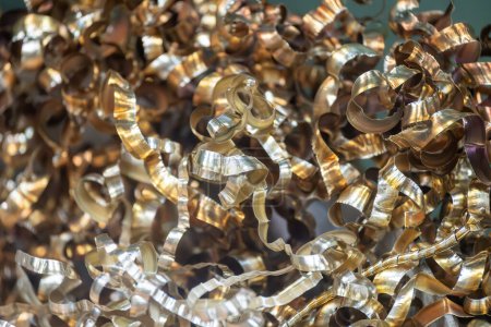 Close-up scene of  the brass materials scrap from turning process. The pile of lathe chips.