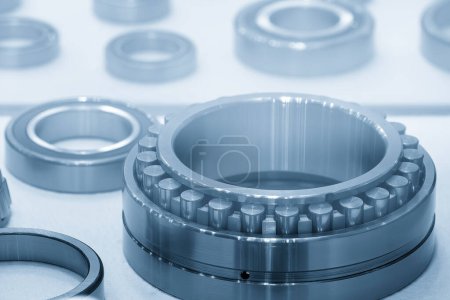 The cylindrical ball bearing parts in the light blue scene. The heavy mechanical part manufacturing concept.