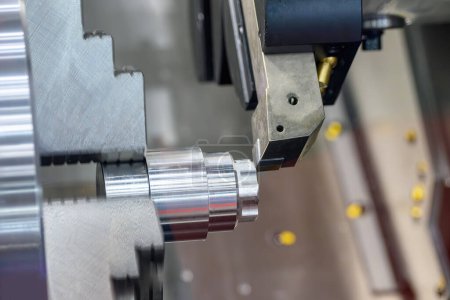 Photo for The  CNC lathe machine forming  cutting the metal shaft parts. The hi-technology metal working processing by CNC turning machine . - Royalty Free Image