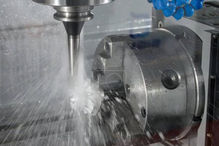 The 4-axis CNC milling machine  cutting the turbocharger part with liquid coolant method. The hi-technology automotive  parts manufacturing process by multi-axis machining center.