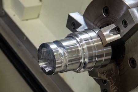 Photo for Close up scene the metal shaft parts chucking at the CNC lathe machine. The hi-technology metal working processing by CNC turning machine . - Royalty Free Image