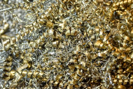 Close-up scene of  the metal materials scrap from turning process. The pile of lathe chips.