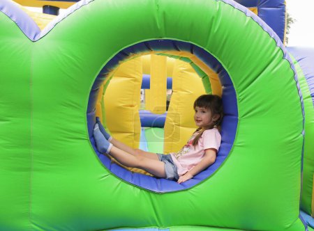 Photo for Ute little girl on an inflatable trampoline - Royalty Free Image
