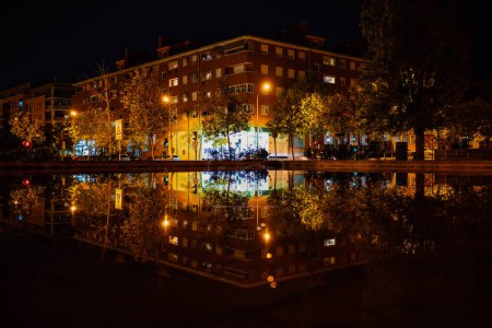 Photo for Residential district Alcobendas , Madrid Spain, with apartment buildings reflected in the water at . - Royalty Free Image