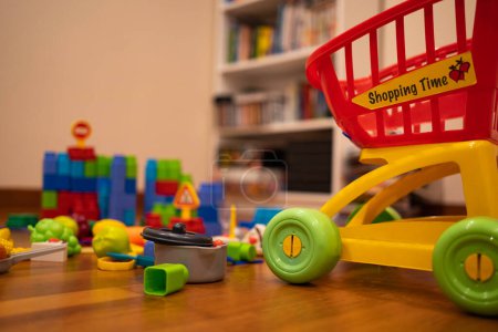 Foto de El lío de los juguetes de los niños en la sala de estar en casa. Sala de juegos para niños pequeños. - Imagen libre de derechos