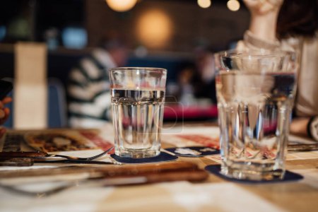 Photo for Background blurred restaurant table setting with people enjoying. - Royalty Free Image