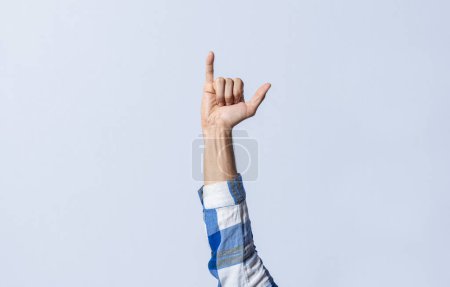 Photo for Hand gesturing the letter Y in sign language on an isolated background. Man's hand gesturing the letter Y of the alphabet isolated. Letter Y of the alphabet in sign language - Royalty Free Image