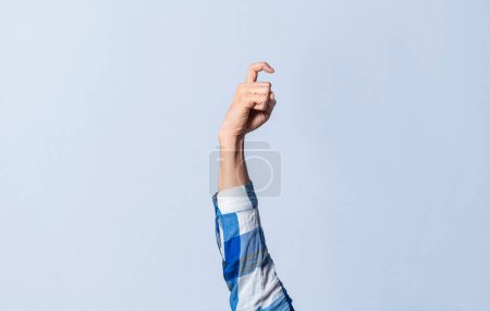 Photo for Hand gesturing the letter X in sign language on an isolated background. Man's hand gesturing the letter X of the alphabet isolated. Letter X of the alphabet in sign language - Royalty Free Image