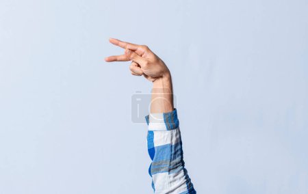 Photo for Hand gesturing the letter P in sign language on an isolated background. Man's hand gesturing the letter P of the alphabet isolated. Letter P of the alphabet in sign language - Royalty Free Image