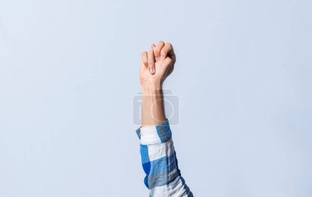 Photo for Hand gesturing the letter N in sign language on an isolated background. Man's hand gesturing the letter N of the alphabet isolated. Letter N of the alphabet in sign language - Royalty Free Image
