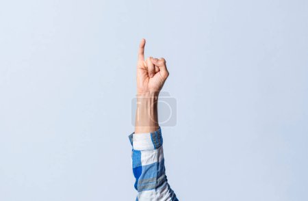 Photo for Hand gesturing the letter I in sign language on an isolated background. Man's hand gesturing the letter I of the alphabet isolated. Letters of the alphabet in sign language - Royalty Free Image