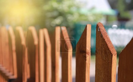 A wooden patio fence with unfocused background, a wooden fence with unfocused background