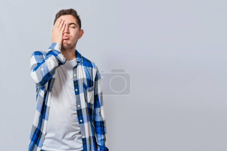 Photo for Exhausted person putting the palm of his hand on his face. Tired and exhausted man covering his face with the palm of his hand isolated, Concept of a bored and tired man - Royalty Free Image