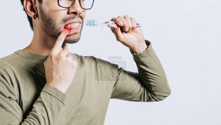 Photo for People holding toothbrush with gum pain. Man holding toothbrush with gum pain, People holding toothbrush with gum problem isolated. Young man with gingivitis holding toothbrush - Royalty Free Image