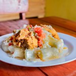 Traditional Chancho dish with Yuca. Nicaraguan pork with yucca served on wooden table