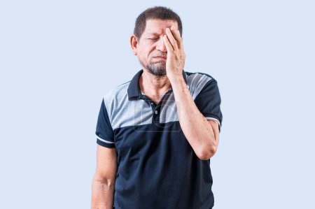 Photo for Tired and exhausted old man covering his face with the palm of his hand. Exhausted senior man putting the palm on his face - Royalty Free Image