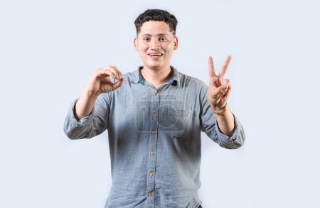 Interpreter man gesturing LOVE AND PEACE in sign language isolated. Smiling person making gesture LOVE AND PEACE in sign language