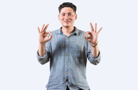 Interpreter person gesturing OK in sign language. Smiling young man gesturing APPROVED in sign language