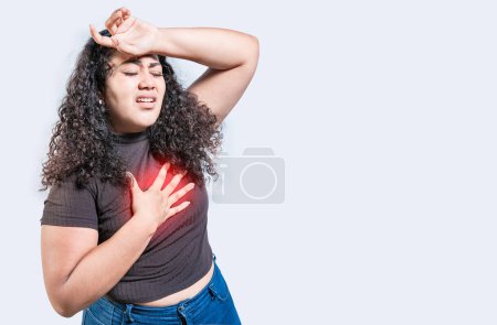 Photo for People with heart problems isolated. Latin woman with heart pain on isolated background. Young woman with tachycardia - Royalty Free Image