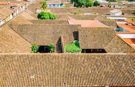 View of the tiled roofs of the colorful buildings in Granada, Nicaragua. Top view of the facade of colorful colonial buildings in the city of Granada