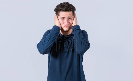 A guy covering his ears, avoiding hearing, deaf ears concept, Man covering his ears on isolated background