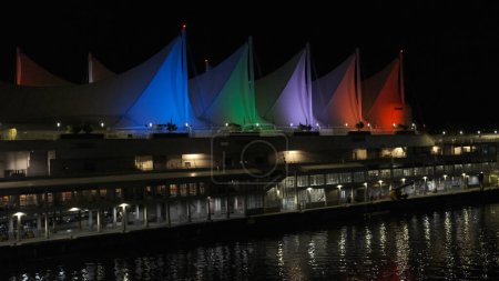 Photo for Canada Place in Vancouver downtown at night. Colorful illuminated sails. Lights reflecting on water surface. - Royalty Free Image