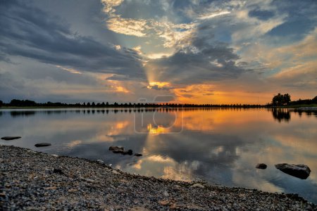 Dramatic sunset and reflections on Patriot Lake in Shelby Farms Park, Memphis, TN. On Sept, 3, 2022
