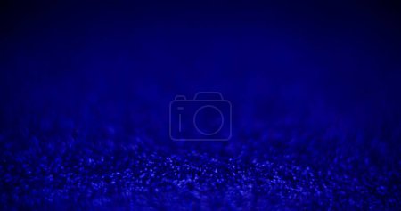 Photo for Defocused light background. Product showcase. Underwater scene. Blur neon blue color glowing particles on dark abstract bubbles texture empty space poster. - Royalty Free Image
