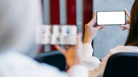 Photo for Mobile communication. Digital mockup. Virtual life. Female hands holding smartphone with blank screen in light room interior. - Royalty Free Image