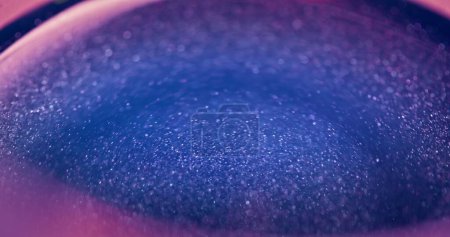 Téléchargez les photos : Glitter background. Neon bokeh light. Galaxy nebula swirl. Defocused blue pink color sparkles glow abstract wallpaper with free space. - en image libre de droit