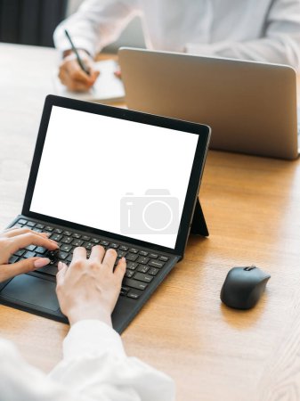 Photo for Office work. Typing woman. Computer mockup. Unrecognizable lady writing laptop blank screen sitting desk with colleague in light room interior. - Royalty Free Image