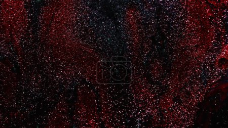 Téléchargez les photos : Glitter texture. Abstract background. Fantasy night sky. Defocused shiny metallic red black color grain paint sparkles on dark free space. - en image libre de droit