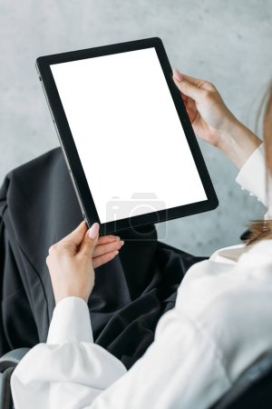 Foto de Virtual connection. Digital mockup. Online meeting. Unrecognizable woman holding tablet computer with blank screen in light room interior. - Imagen libre de derechos