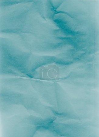 Foto de Creased paper texture. Distressed overlay. Wrinkled noise. Blue color grain dust scratches on light uneven rough abstract copy space background. - Imagen libre de derechos