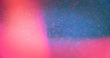 Foto de Neon bokeh light. Blur glitter glow. Glamour sequin sparkles. Defocused fluorescent blue pink color shiny circles lens flare abstract background with free space. - Imagen libre de derechos