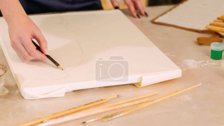 Photo for Drawing art. Creative hobby. Talent skill. Closeup of female artist hand using graphite pencil for sketching artwork on white canvas at workplace. - Royalty Free Image