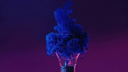 Foto de Ink shot in broken lamp. Neon background. Blue color fluid splash smoke cloud filling cracked glass light bulb in water on dark purple abstract copy space. - Imagen libre de derechos