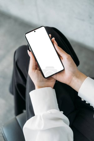 Photo for Mobile connection. Digital mockup. Virtual meeting. Unrecognizable woman holding smartphone with blank screen in hands light room interior. - Royalty Free Image