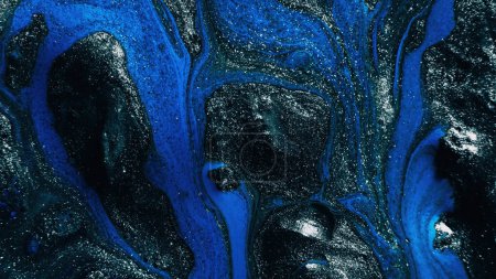 Photo for Fluid art. Glitter paint. Marble texture. Defocused shimmering silver gray blue black color ink blend wave on dark abstract background. - Royalty Free Image