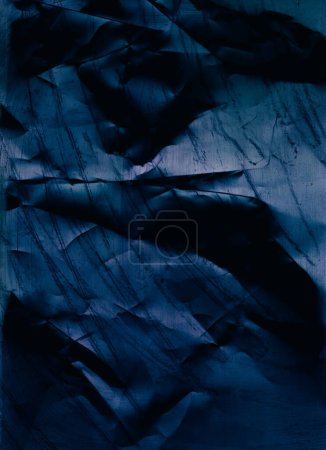 Téléchargez les photos : Creased texture. Distressed paper. Wrinkled noise. Blue color grain dust scratches on dark uneven rough grunge abstract background. - en image libre de droit
