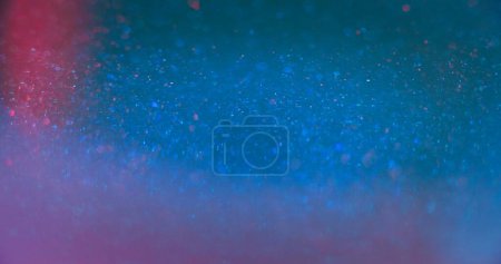 Téléchargez les photos : Neon glitter texture. Bokeh light flare. Shimmering sequin glare. Defocused blue pink color sparkling circles glow lens flare abstract background with free space. - en image libre de droit