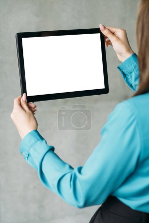 Photo for Digital mockup. Advertising background. Mobile technology. Unrecognizable woman office look holding tablet computer with blank screen. - Royalty Free Image