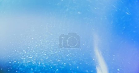 Photo for Blur sparkles overlay. Bokeh light texture. Snow flakes in sky. Defocused blue white color particles glow lens flare abstract background with free space. - Royalty Free Image