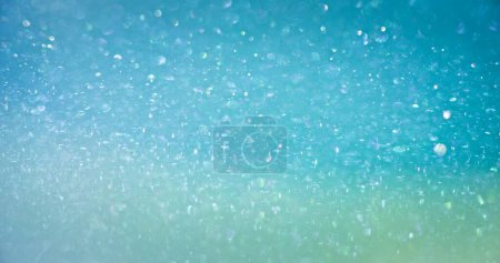 Photo for Bokeh light overlay. Blur circles texture. Shimmering sparkles. Defocused blue green color gradient round flecks glow abstract background with copy space. - Royalty Free Image