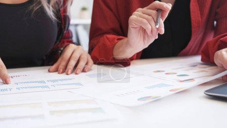 Photo for Market analysis. Business report. Financial statistics review. Unrecognizable female team discussing strategy working with charts graphs. - Royalty Free Image