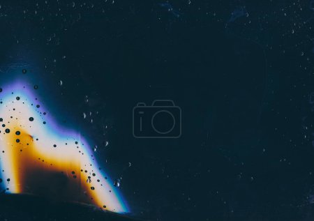 Photo for Wet glass. Distressed overlay. Aged film. Orange blue rainbow flare rain drops dust scratches noise on dark black weathered window texture abstract illustration background. - Royalty Free Image