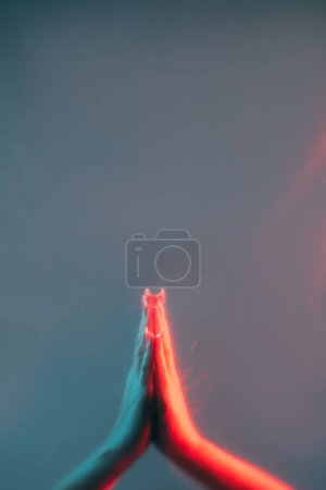 Photo for Prayer hands. Spiritual faith. Forgiveness salvation. Worship belief. Red blue color light defocused holy namaste gesture on empty space background. - Royalty Free Image