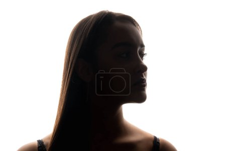 Photo for Female silhouette. Beauty model. Facelift skin rejuvenation. Backlit profile portrait of confident woman face on white free space background. - Royalty Free Image
