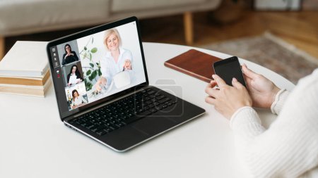 Photo for Web chat. Video call. Remote conference. Business woman working from home watching female colleagues communicating online on laptop screen at workplace. - Royalty Free Image